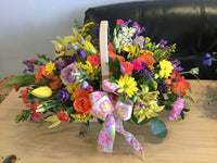 Rainbow colurs basket created in a variety of seasonal flowers , florist choice. Size in picture is medium 
